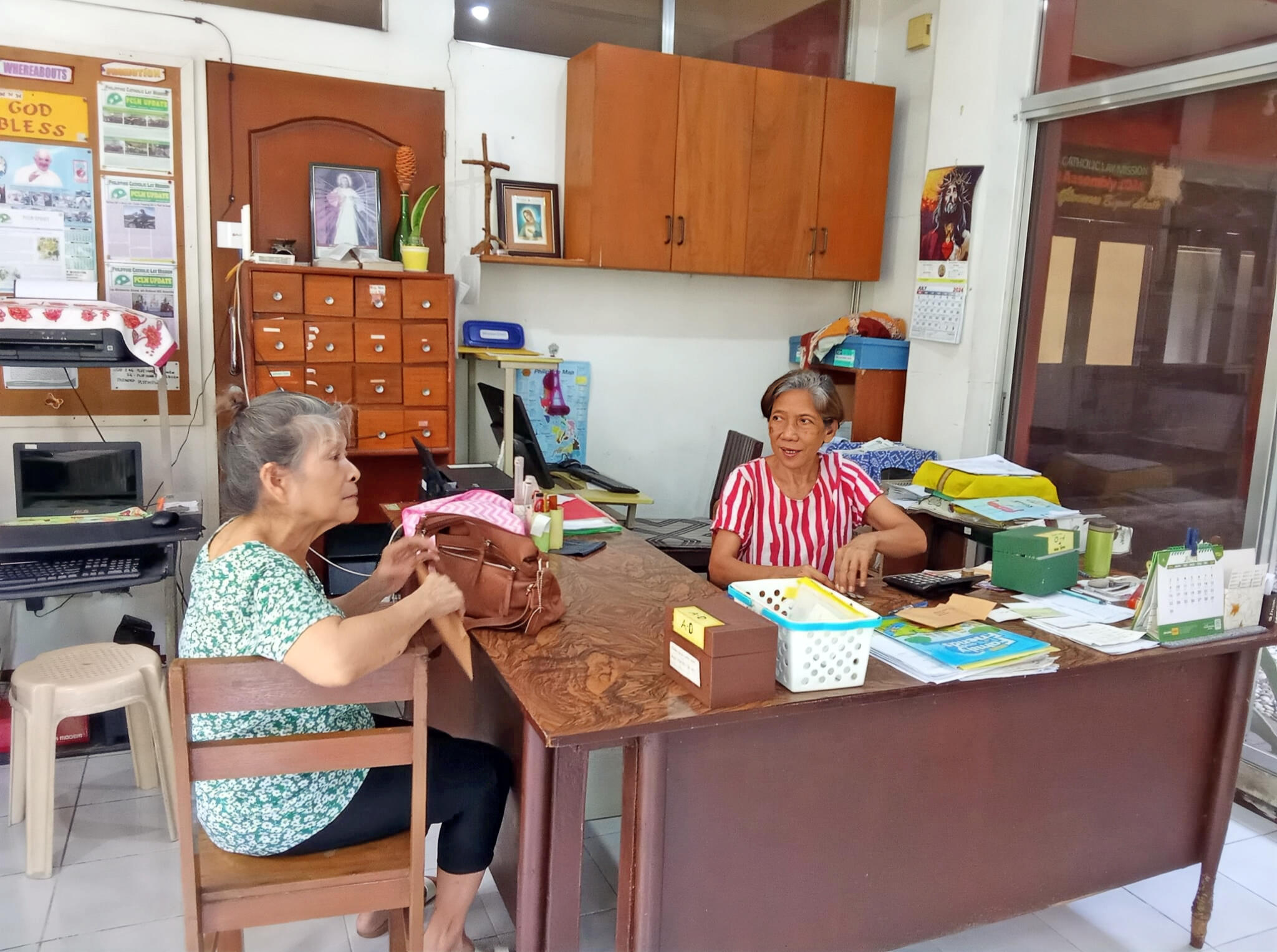 Modesta Espino, a PCLM Mission Partner and retired teacher, gives her donation to PCLM Staff Evangeline Pico. She began with 50 pesos and made a promise to God to increase her contribution until she reached 500 pesos per month. She achieved her goal!